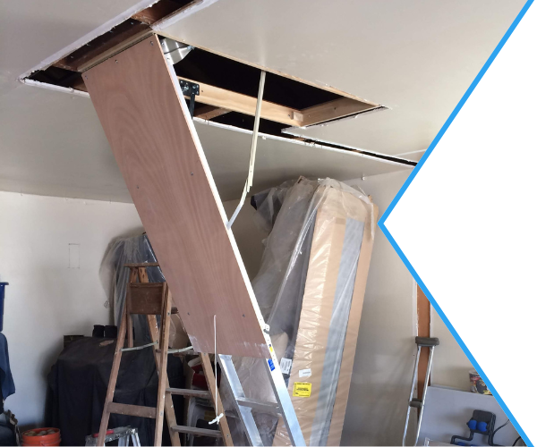 Professional handyman installing a secure, foldable attic ladder in a modern home in North San Diego County, ensuring safe and easy attic access.