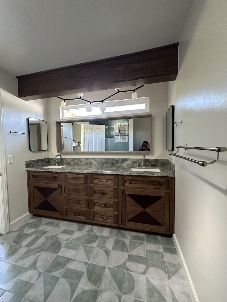 Finished Vista master bathroom with custom walnut double vanity, wrapped beam and exposed window