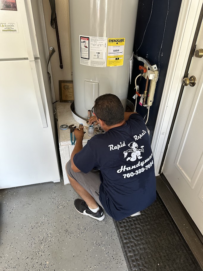 Rapid Repair Handyman technician working on a water heater installation in a Fallbrook garage