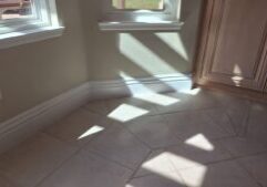 Reconstructed interior wall and white baseboards beneath windows beside cabinetry in Rancho Santa Fe